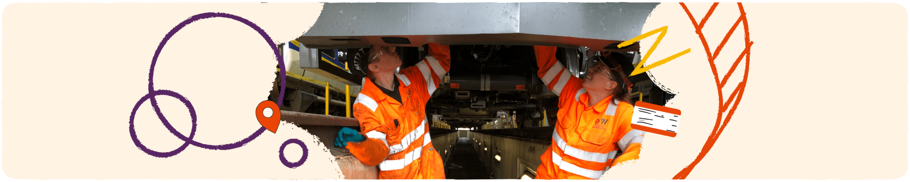 Two apprentices working underneath a train
