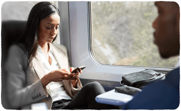 Business person using her phone on the train