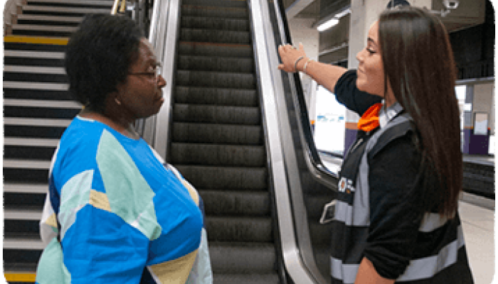 Railway staff member directing a member of the public