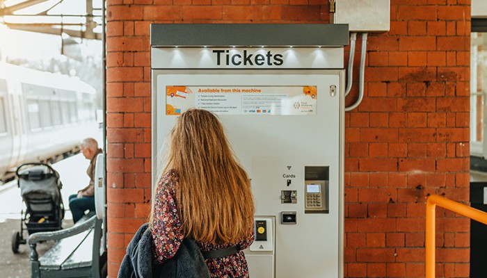 Rail passenger buying tickets via a ticket vending machine