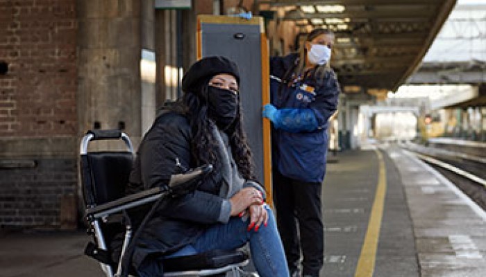 Woman in wheelchair waiting for a train