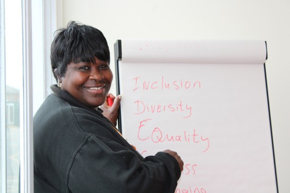 Jackie writing inclusion activities on a whiteboard.