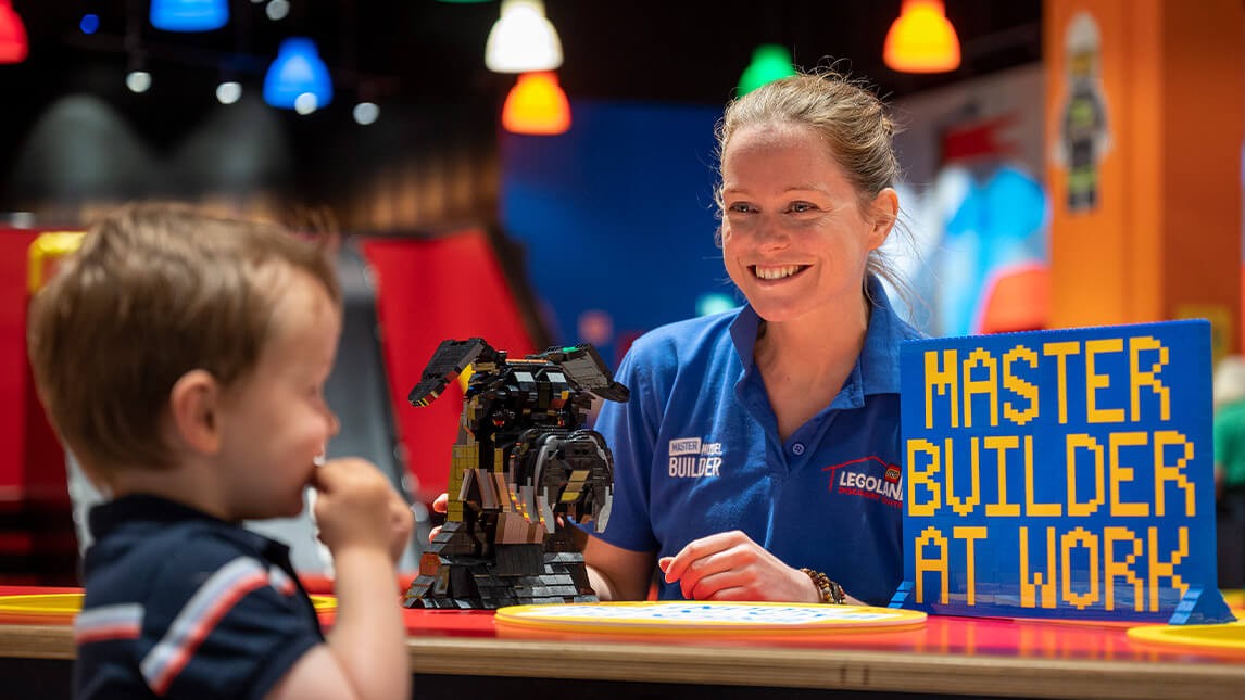 Child and Lego Staff member having fun at Legoland discovery